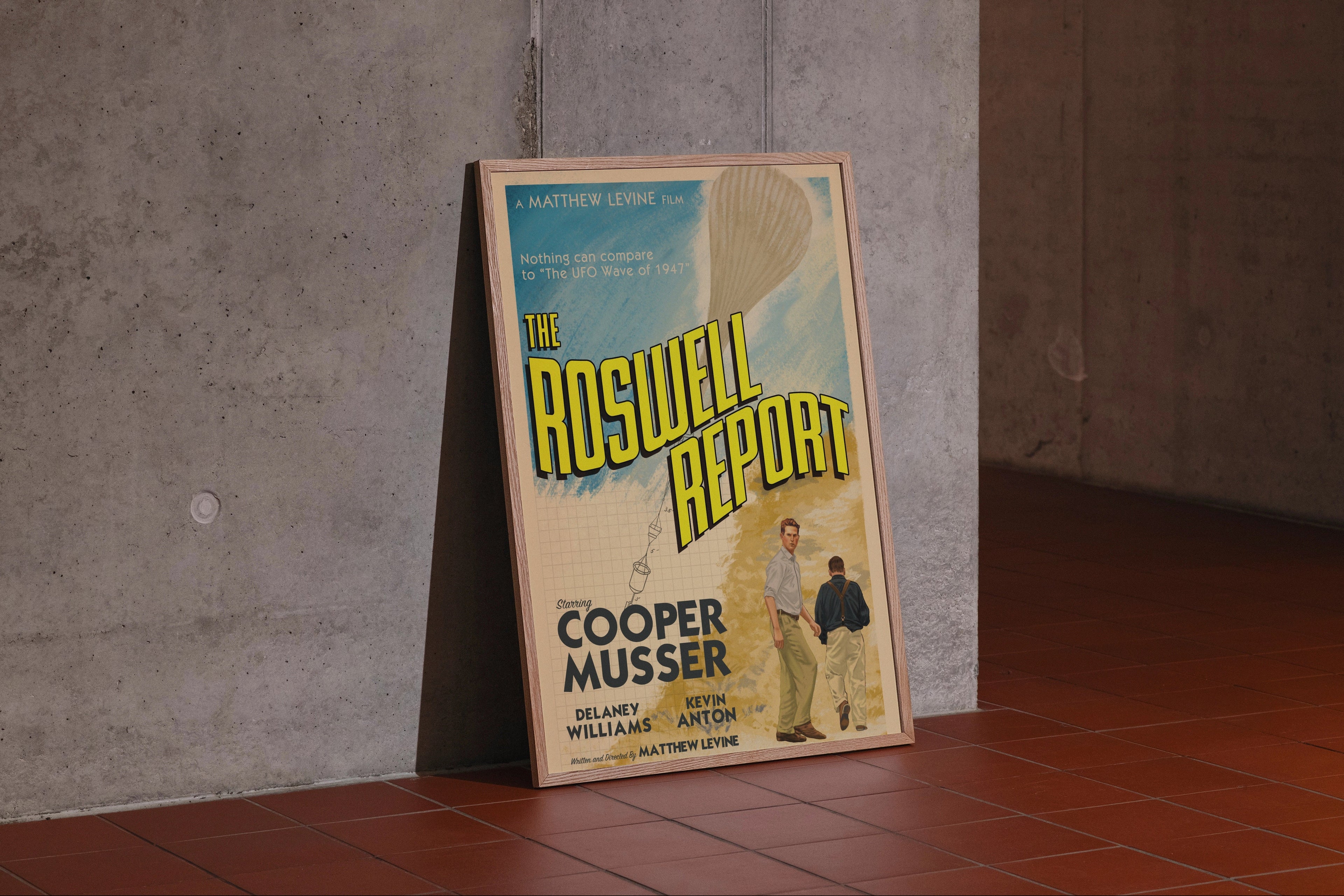 Poster of 'The Roswell Report' leaning against a concrete wall.
